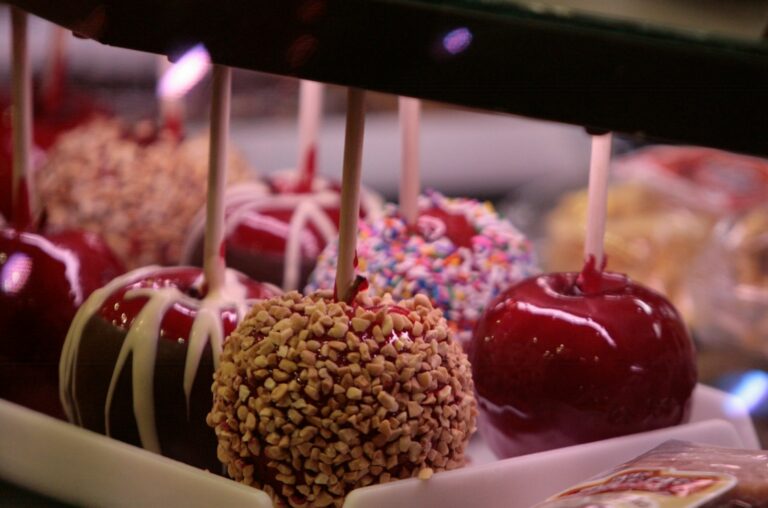 a group of fruits with sticks in them